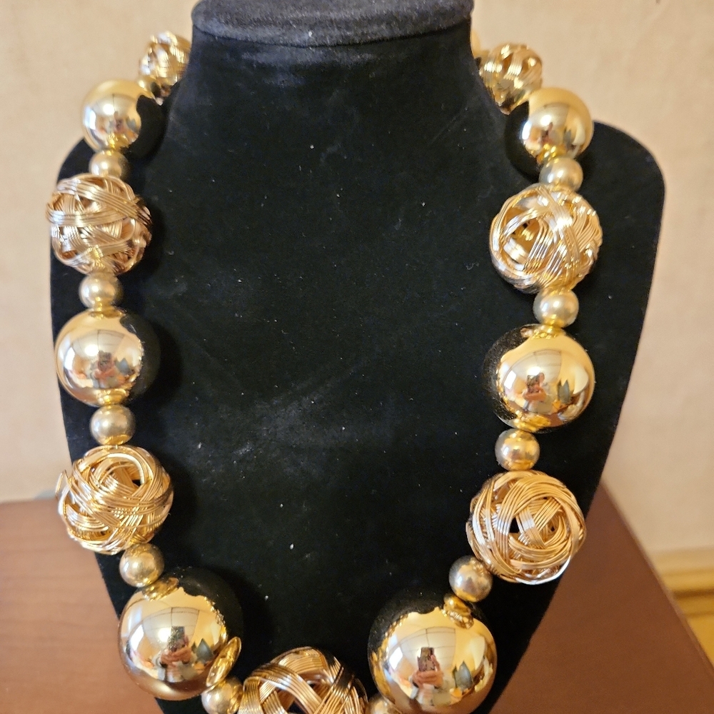 Bold statement necklace w/ large gold beads of various styles. EUC